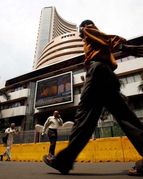 Commuters walk past the Bombay Stock Exchange building in Mumbai.