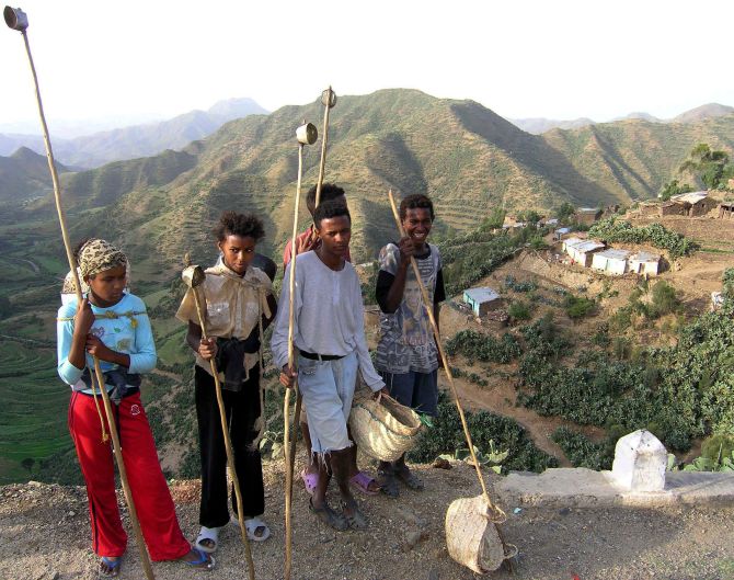 Eritrean kids pose for the camera before heading up the mountainside.