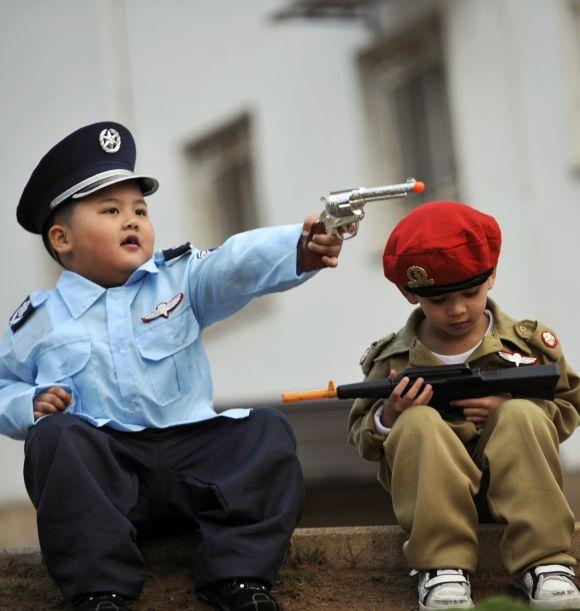 Children dressed in costume sit together during a party celebrating.