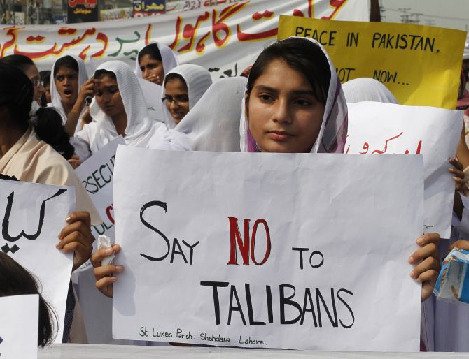 Members of the Pakistani Christian community hold placards during a protest rally in Lahore.