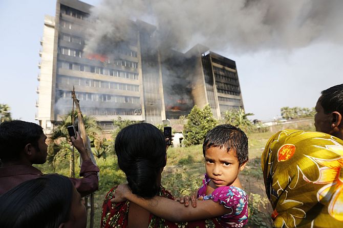 Garment workers gather in front of the Standard Group garment factory which was on fire in Gazipur.