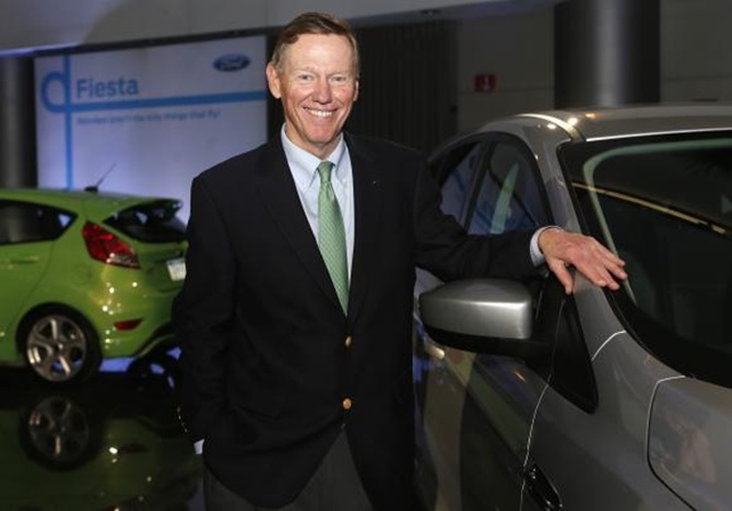 Ford Motor Co. CEO Alan Mulally poses next to a Ford vehicle during a gathering with members of the media at the Ford Conference Center in Dearborn, Michigan.