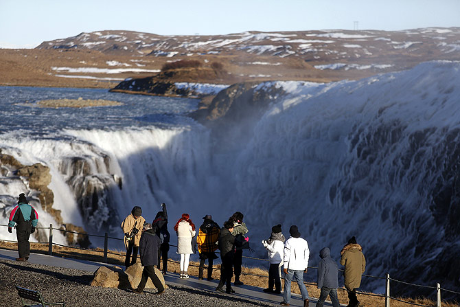 People walk near Gullfoss waterfall in southwestern Iceland.