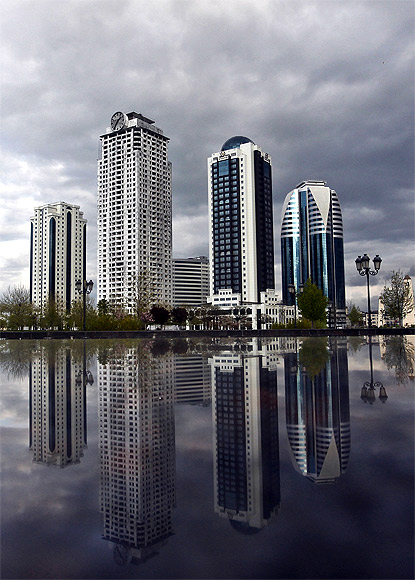 The skyscrapers are against the city skyline.