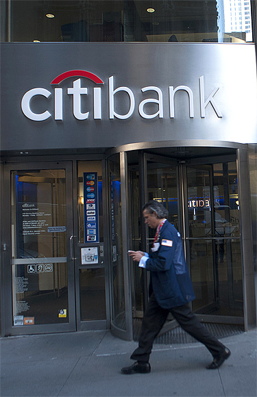Passersby walk in front of a Citibank branch in New York.