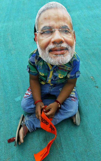 A boy wearing a mask of Hindu nationalist Narendra Modi, prime ministerial candidate for India's main opposition Bharatiya Janata Party.