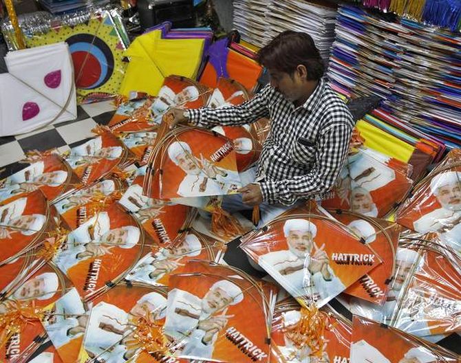 A kite maker counts kites with images of Hindu nationalist Narendra Modi, prime ministerial candidate for India's main opposition Bharatiya Janata Party.