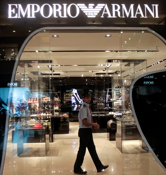 A security guard walks inside a Giorgio Armani showroom in a shopping mall.