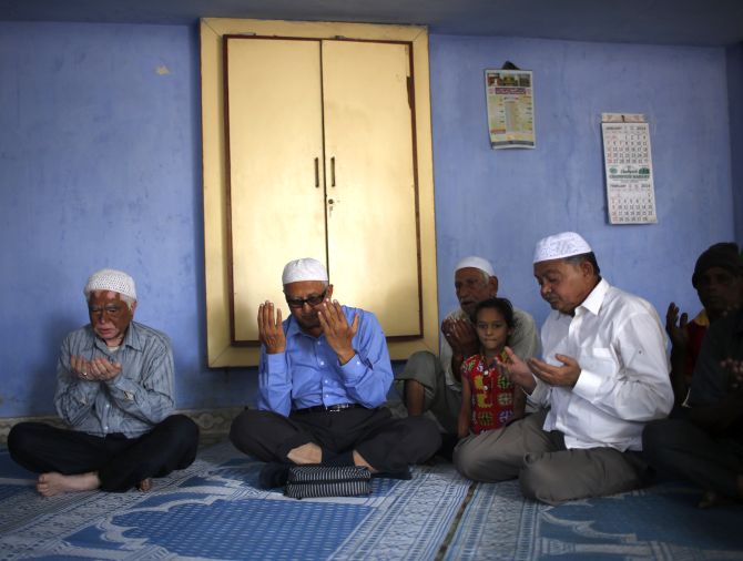 Survivors of the 2002 Gujarat riots offer prayers to mark the 12th anniversary of riots inside a mosque at the Gulbarg Society, a Muslim-dominated housing, in the western Indian city of Ahmedabad.