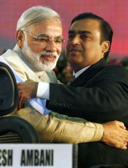 Indian Prime Minister Narendra Modi (L) embraces Mukesh Ambani, chairman of Reliance Industries, during the Vibrant Gujarat Global Investors' Summit 2011.