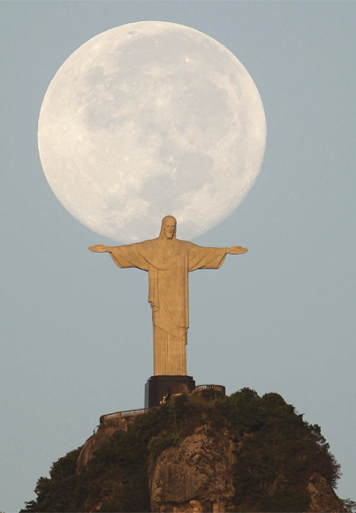 A full moon is seen over the Christ the Redeemer statue in Rio de Janeiro.