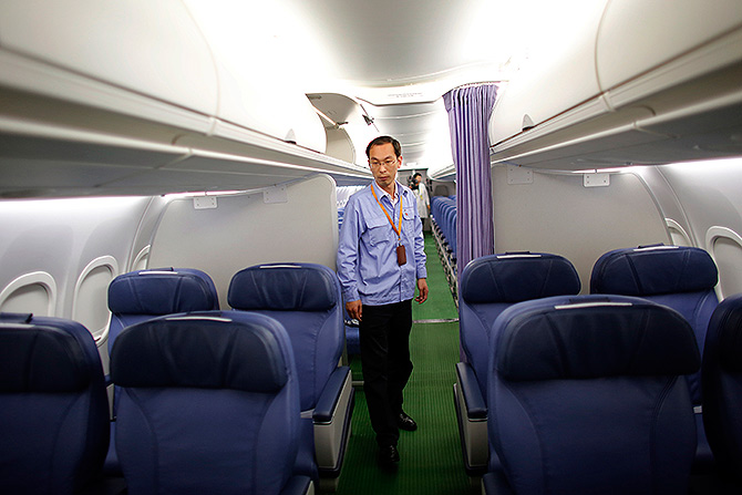 A technician inspects a ARJ21-700 aircraft model at the Commercial Aircraft Corp of China Ltd (Comac) factory in Shanghai.