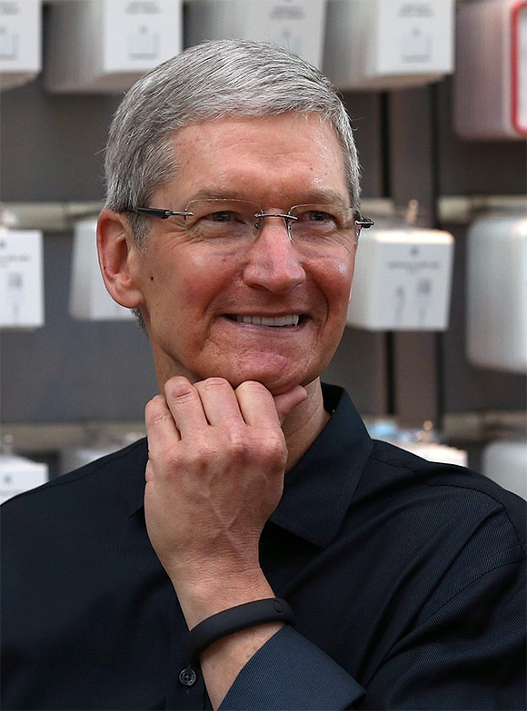 Apple CEO Tim Cook looks on before the Apple Store opens.