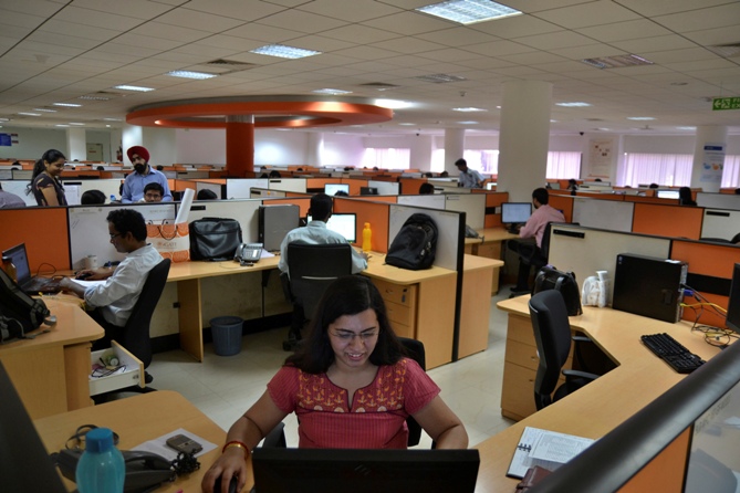 Employees work at the Indian headquarters of iGate in Bengaluru.