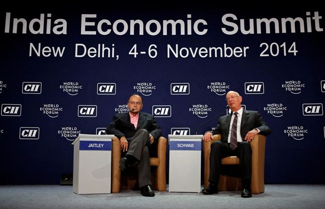 Finance Minister Arun Jaitley (L) and World Economic Forum founder and executive chairman Klaus Schwab attend a session at the India Economic Summit 2014