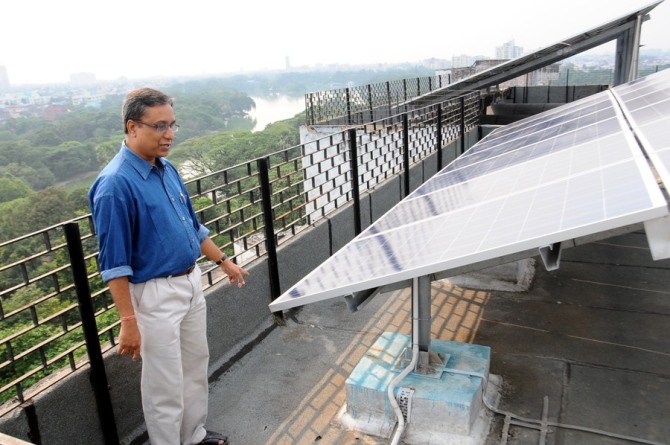 Avijit Ghosh with the solar panels