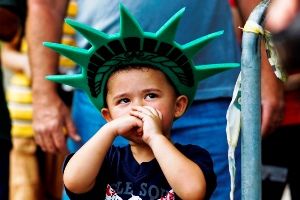 A child attends a ceremony to reopen the Statue of Liberty and Liberty Island to the public in New York July 4, 2013. 