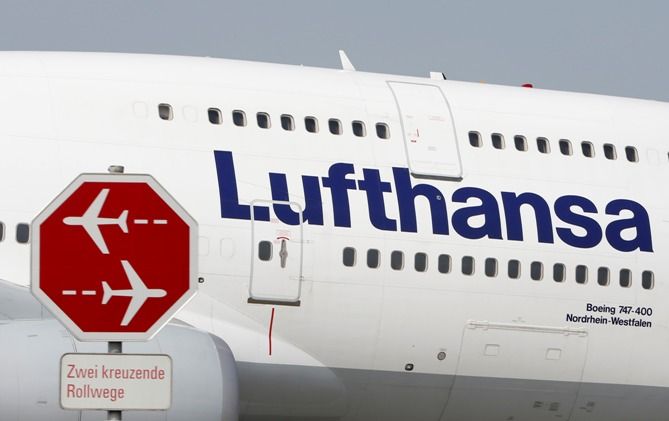 German airline Lufthansa aircraft taxis past a sign during a pilots' strike at Munich's airport on September 10, 2014.