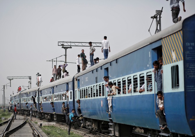 Passengers stand on top of an overcrowded train at Loni town in Uttar Pradesh. Anindito Mukherjee/Reuters