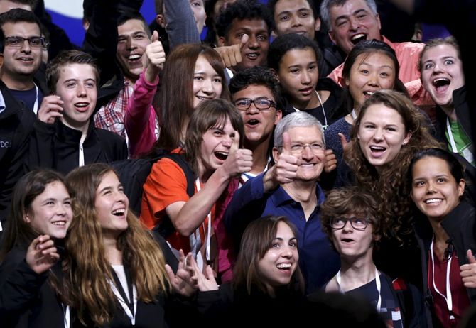 Apple chief Tim Cook poses with scholarship winners following his keynote address at the Worldwide Developers Conference in San Francisco, California June 8, 2015.
