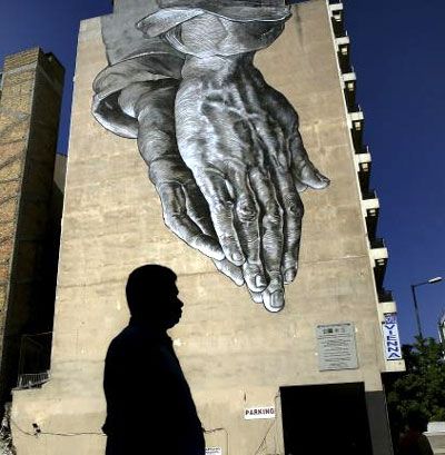 A pedestrian walks through empty streets by a mural in Athens, Greece July 12, 2015. Photograph: Yannis Behrankis/Reuters 