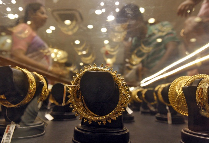 Image: Gold bracelets are on display as a woman (left) makes choices at a jewellery showroom on the occasion of Akshaya Tritiya, a major gold buying festival, in Kolkata. Rupak De Chowdhuri/Reuters