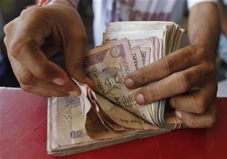 A man counts rupee notes
