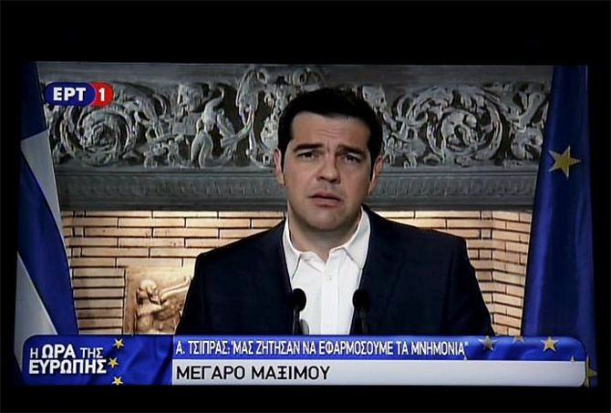 Image: Greek Prime Minister Alexis Tsipras is seen on a television monitor while addressing the nation. Photograph: Reuters 