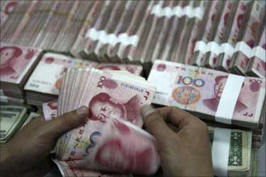 An employee counts yuan banknotes at a branch of the Industrial and Commercial Bank of China.
