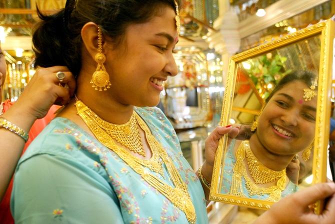 A model displays gold jewellery.