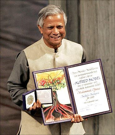 Nobel Peace Prize winner Muhammad Yunus of Bangladesh poses with his award during a ceremony at the city hall in Oslo.