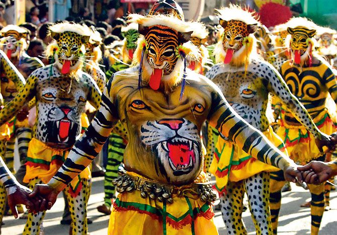 Image: Thrissur’s puli kali features men whose bodies are painted with tiger stripes and leopard spots. Photograph: Dipak/Reuters