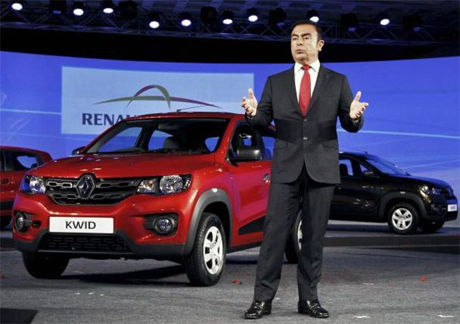 Carlos Ghosn, CEO of the Renault-Nissan Alliance, speaks to the media as he stands next to Renault's new Kwid car during its launch in Chennai. 