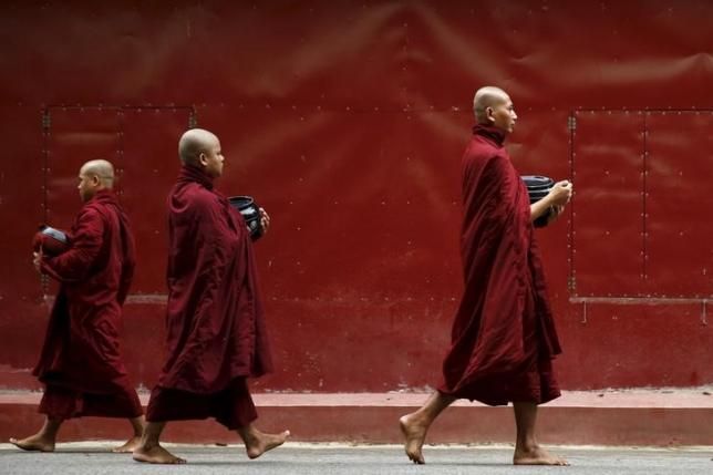 Buddhist monks walk inside the Masoyein monastery complex in Mandalay