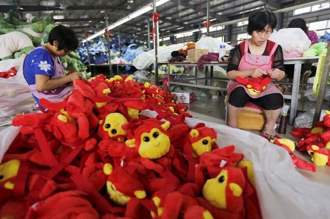 Workers make stuffed dolls which are to exported to Europe and north America, at a factory in Lianyungang, Jiangsu province, China.