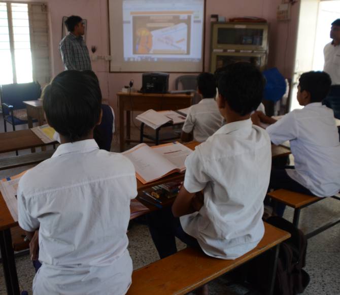 Pinkesh Raval uses a K-Yan to teach the children about India's social reformers. After every session he asks them questions to check if they have grasped the topic well