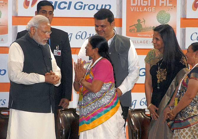 Prime Minister Narendra D Modi dedicated ICICI Bank's Digital Village to the nation, January 2, 2015. To Modi's left is Maharashtra Chief Minister Devendra Fadnavis and ICICI Bank MD and CEO Chanda Kochhar. Photograph: Kind courtesy narendramodi.in