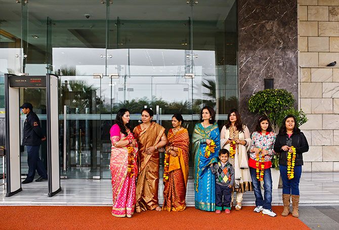 Guests hold marigold garlands to receive their relatives outside the Holiday Inn, run by the InterContinental Hotels Group, New Delhi. Photo: Anindito Mukherjee/Reuters