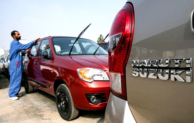 A worker cleans a parked car at the Maruti Suzuki's stockyard on the outskirts of Jammu January 4, 2011. Photo: Mukesh Gupta/Reuters