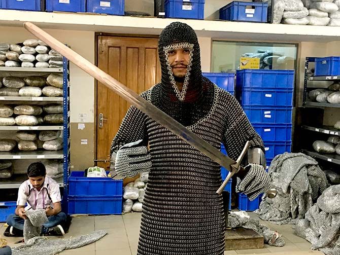 A worker poses with chain mail