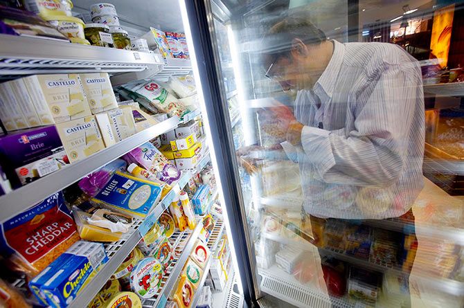 A customer examines a packet of cheese in the processed dairy food section of a supermarket in Mumbai May 30, 2011. Photo: Vivek Prakash/Reuters