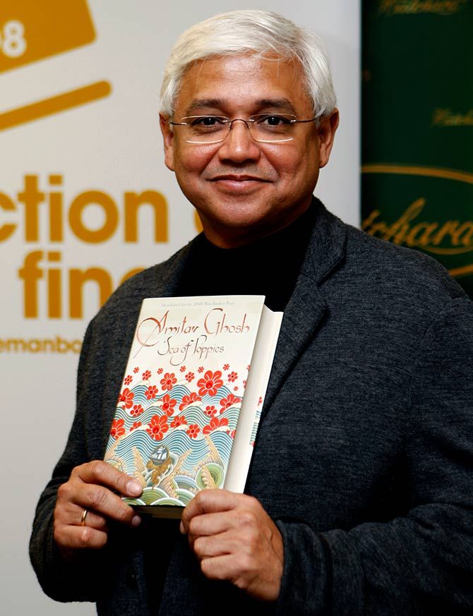Man Booker Prize shortlist nominee Indian author Amitav Ghosh poses with his book Sea of Poppies ahead of the announcement of the winner in central London, October 14, 2008. Photo: Stephen Hird/Reuters   