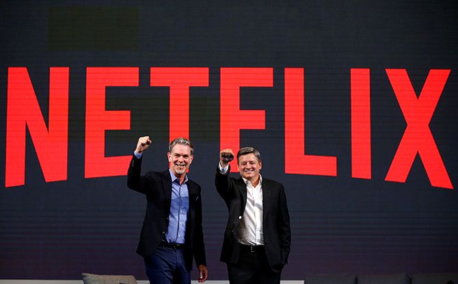 Reed Hastings, co-founder and CEO of Netflix, and Ted Sarandos, Netflix chief content officer, pose for photographs during a news conference in Seoul, South Korea, June 30, 2016. Photo: Kim Hong-Ji/Reuters
