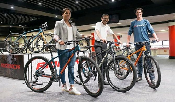 Three-time BMX world champion Shanaze Reade, from Crewe, left, with Avocet Sports Limited’s CEO Sreeram Venkateswaran and Patrick Robinson, International free-rider from Wakefield, far right. Photograph: PTI.   