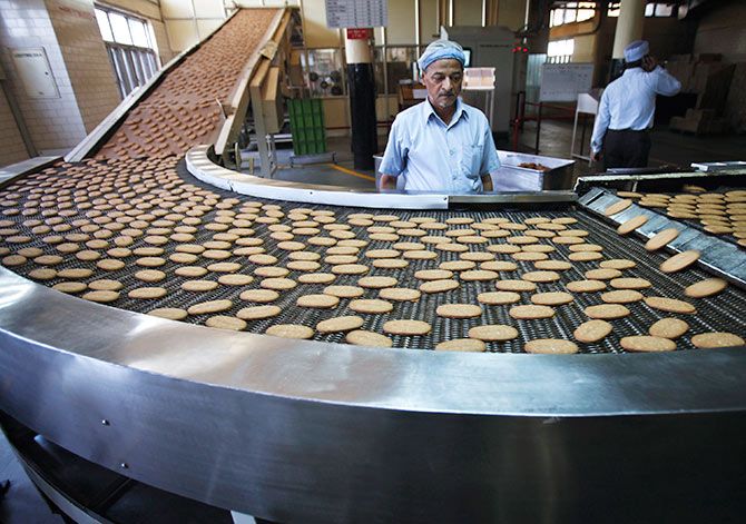 Biscuits on a conveyor belt after being baked at the Britannia factory in New Delhi. Photograph: Adnan Abidi/Reuters.