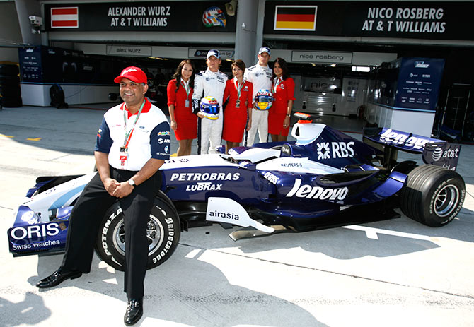 Tony Fernandes, left, Group CEO of AirAsia, poses with Williams' Formula One drivers, Nico Rosberg of Germany and Alexander Wurz, second right, of Austria during a photocall in conjunction with the Malaysian F1 Grand Prix, Sepang, Malaysia. AirAsia is one of the new sponsors for Williams' Formula One team. Photograph: David Loh/Reuters.