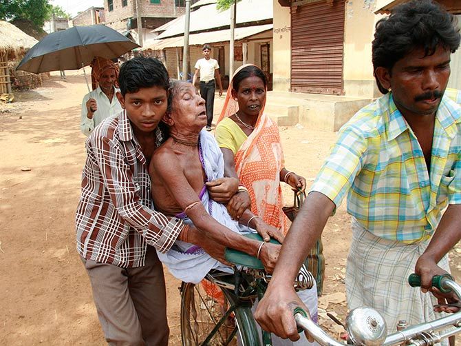 A woman being transported to the hospital at Lalgarh, West Midnapore district, some 170 km west of Kolkata. Photograph: Jayanta Shaw/Reuters.