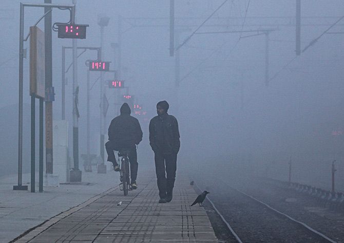 On a railway platform on a foggy winter morning in Chandigarh. Photograph: Ajay Verma/Reuters.