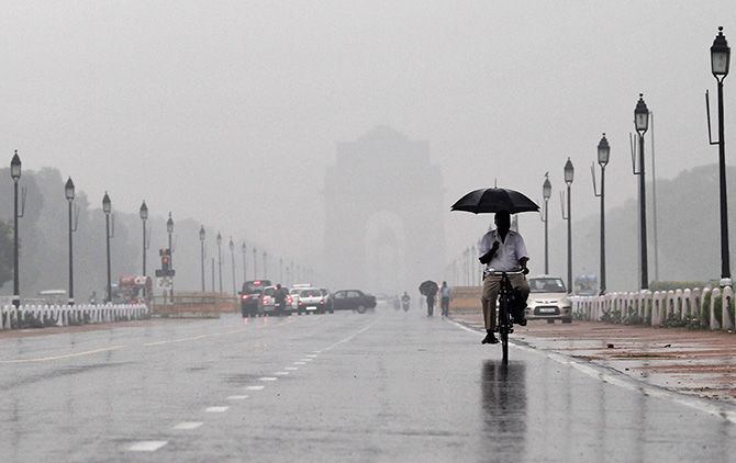 Cycling near India Gate, New Delhi. Photograph: Adnan Abidi/Reuters.