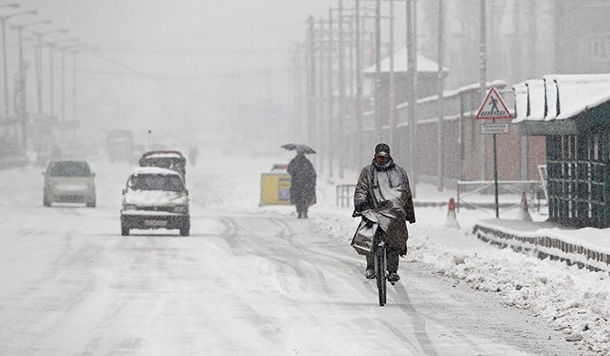 Braving the weather in Srinagar, Kashmir, Photograph: Danish Ismail/Reuters.